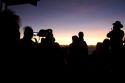 Tourists using digital cameras await the sunrise atop Mount Haleakala on the island of Maui, Hawaii.