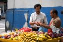 Man shopping at a fruit stand in Sao Paulo, Brazil.