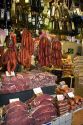 Cured meats, sausages, and olive oil being sold at the Mercado Municipal in Sao Paulo, Brazil.