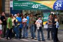 People standing in front of a store waiting for a bus in Sao Paulo, Brazil.