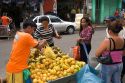 People buying fruit from a street vendor in Manaus, Brazil.