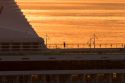 A man jogging at sunrise on the deck of a cruise ship docked in Manaus, Brazil.