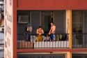 People on the balcony of their apartment at sunrise in Manaus, Brazil.