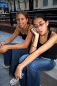 Argentine teenage girls,  one speaking on a cell phone in Buenos Aires, Argentina.