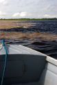 The bow of a boat at the confluence of the Amazon River and the Rio Negro at Manaus, Brazil.