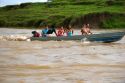 Brazilians ride in a small river boat on the Amazon River near Manaus, Brazil.