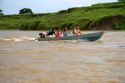 Brazilian people ride in a small river boat on the Amazon River near Manaus, Brazil.
