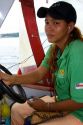 Brazilian woman listens to an MP3 player while driving an Amazon river boat at Manaus, Brazil.