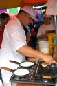 A man cooking tapioca into a kind of pancake in Manaus, Brazil.