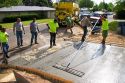 Workers pouring and leveling a concrete driveway in Boise, Idaho.