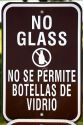 A bilingual sign saying No Glass in english and spanish languages.