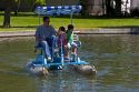 Father and daughters ride on a paddle boat in Boise, Idaho.