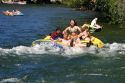 People on inflatable rafts floating the Boise River in Boise, Idaho.