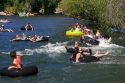 People on tubes and inflatable rafts floating the Boise River in Boise, Idaho.