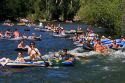 People on inflatable rafts floating the Boise River in Boise, Idaho.