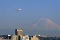 Sea plane flying over Seattle with Mount Rainier in the background in Washington.