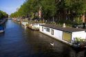 Houseboats docked along the Amstel River in Amsterdam, Netherlands.