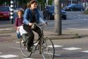 Woman and child riding on a bicycle in Amsterdam, Netherlands.