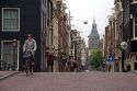 Man riding a bicycle on the street in Amsterdam, Netherlands.