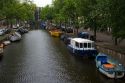 Canal boats docked near the Amstel River in Amsterdam, Netherlands.