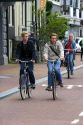 People riding bicycles on the street in Amsterdam, Netherlands.