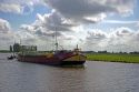 Boat traveling on a canal east of Leiden in the province of South Holland, Netherlands.