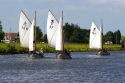 Sailboats travel on a canal east of Leiden in the province of South Holland, Netherlands.