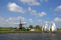 Sailing past a windmill on a canal east of Leiden in the province of South Holland, Netherlands.