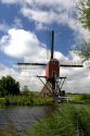 Windmill along a canal east of Leiden in the province of South Holland, Netherlands.