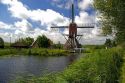 Windmill along a canal east of Leiden in the province of South Holland, Netherlands.