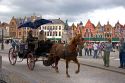 A horse drawn carriage at The Big Market Square in the city of Bruges in the province of West Flanders, Belgium.