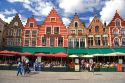 Cafes line The Big Market Square at Bruges in the province of West Flanders, Belgium.