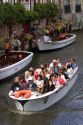 Tourists ride in a canal boat at the city of Bruges in the province of West Flanders, Belgium.
