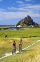 Bicyclists ride on trails near Le Mont Saint Michel in the region of Basse-Normandie, France.