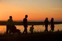 A family walks at sunset near Le Mont Saint Michel in the region of Basse-Normandie, France.