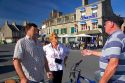 French residents talk on the street in the commune of Barfleur in region of Basse-Normandie, France.