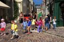 A group of adult supervised French children crossing the street at Bayeux in the region of Basse-Normandie, Normandy, France.