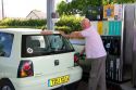 French man fueling up his car at a gas station in Bayeux in the region of Basse-Normandie, Normandy, France.