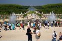 Tourists stand by fountains in the formal gardens of The Palace of Versailles at Versailles in the department of Yvelines, France.