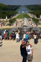 Tourists take photographs by fountains in the formal gardens at The Palace of Versailles at Versailles in the department of Yvelines, France.