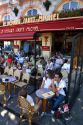 People dine outdoors at the Cafe Le Depart Saint-Michel, open 24 hours in Paris, France.