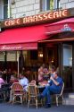 People dine outdoors at a cafe in Paris, France.