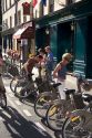 People use rental bicycles that are a part of the Velib bike transit system in Paris, France.