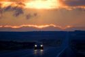 Car driving at sunset on highway 20 near Idaho Falls, Idaho.