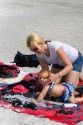 Mother applying sunscreen to her infant daughter at the beach in St. Petersburg, Florida. MR