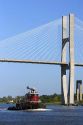 A tugboat passes under the Talmadge Memorial Bridge on the Savannah River at Savannah, Georgia.