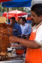 Street vendor cooking and cutting meat for souvlaki in Mexico City, Mexico.