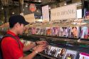 A young mexican man shopping for Spanish language cd's at a music store in Mexico City, Mexico.