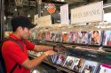 A young Mexican man shopping for Spanish language cd's at a music store in Mexico City, Mexico.