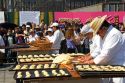 Bread being made in the shape of a skull to be givin away to the crowd of people celebrating Day of the Dead in the Zocalo in Mexico City, Mexico.